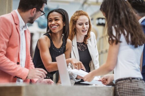 People discussing event budgeting over a table.