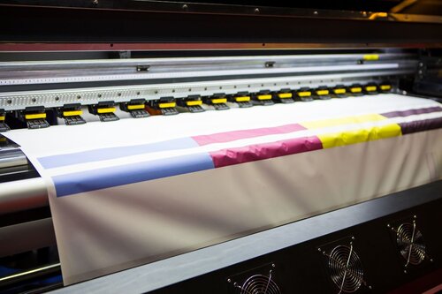 Large format printer printing CMYK color bars for trade show display production