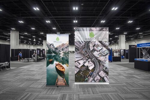 Retractable banner stands from Ace Displays in an aisle of a trade show.