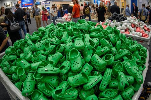Large container full of green crocs