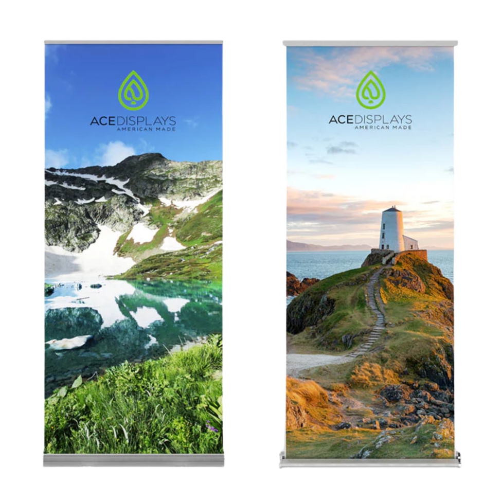 Ace Displays customizable banner stands, one with a greenscape graphic and another with a beach scene with a lighthouse.