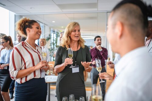 People chatting at an event.