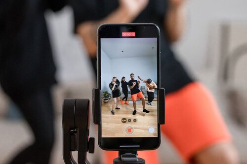 Center focus of a group of people filming a reel.