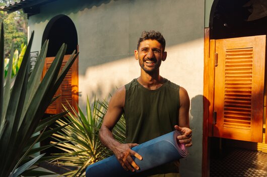 Solopreneur smiling outdoors, relaxed and confident.