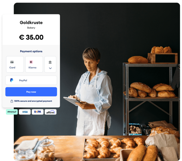 Baker in her shop — with Jimdo's payment page in the foreground showing card, Klarna, and PayPal options for a €35 order.