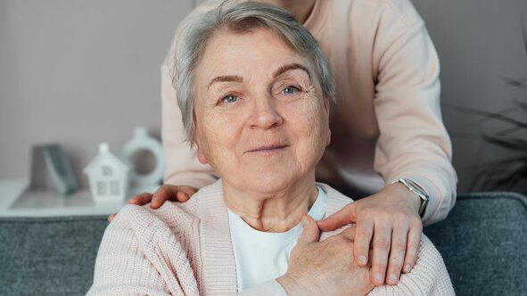 A close, reassuring moment between a senior and a Helper at home. Herewith provides compassionate in-home senior care services focused on dignity, comfort, and personalized daily support.