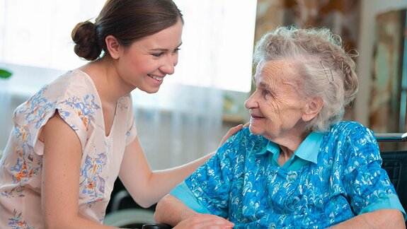 A Helper shares a warm moment with a senior, offering companionship and emotional support. In-home care can improve quality of life and overall well-being.