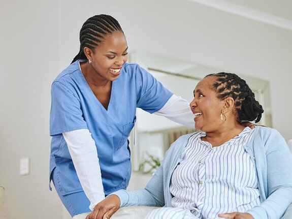 A compassionate Helper supports a senior woman in her home, offering personalized care and encouragement. Find experienced Helpers through Herewith for dependable, relationship-based senior care.