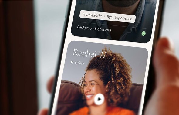 A person holds a smartphone showing a Helper’s profile with the name Rachel W., photo, distance, and service information.