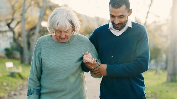 A trusted Helper supports safe mobility and companionship for an older adult. Find reliable in-home senior care in Phoenix with Herewith.