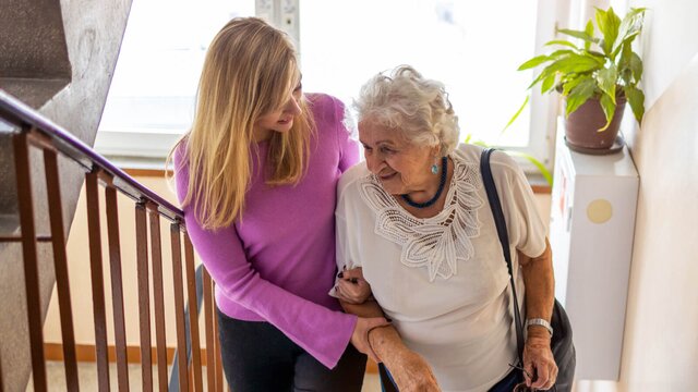 A Helper gently supports an older adult at home. Herewith connects families with reliable Helpers for safe, everyday in-home care.