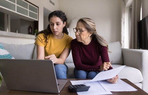 A family are looking at their computer trying to understand their tax deductions