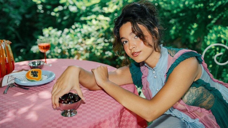 Mari Froes sitting at table 