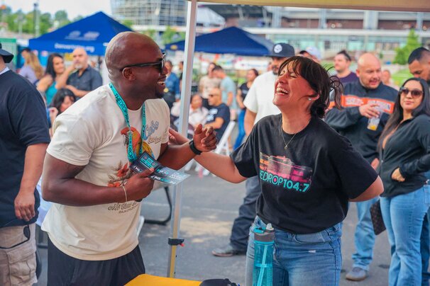 Molly laughing with listener at Drop booth 