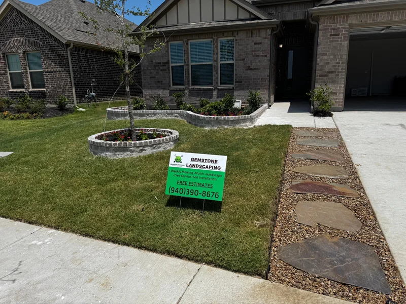 Completed landscape project with new lawn and garden beds