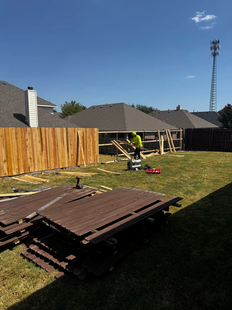 Crew building a new cedar privacy fence