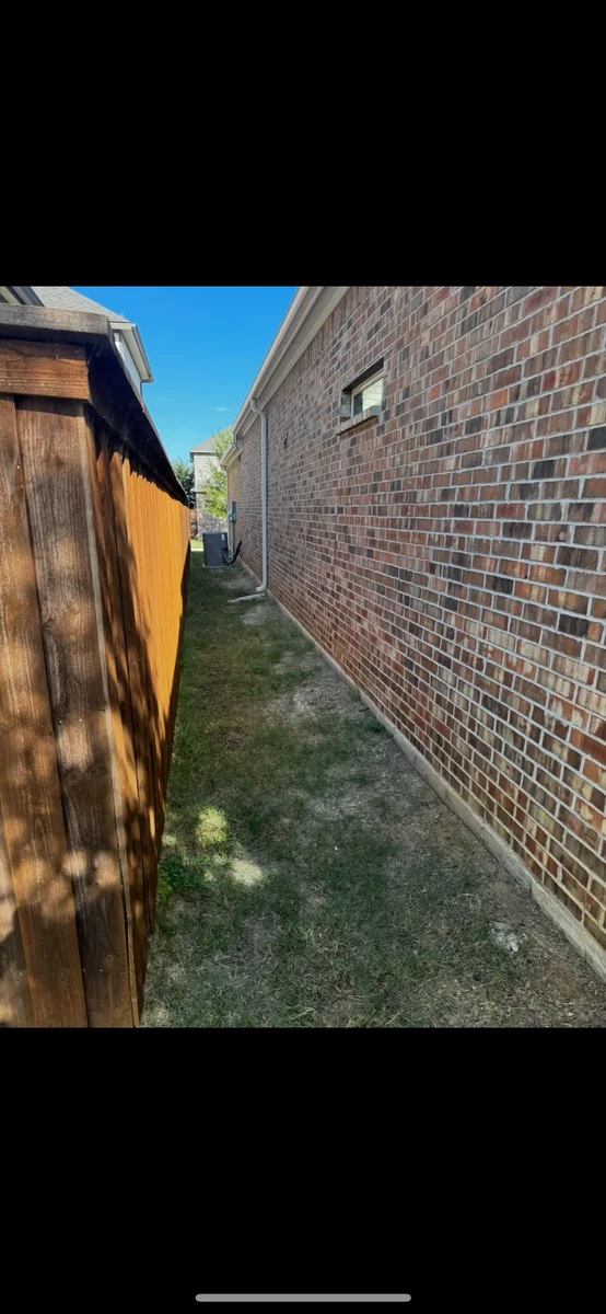 Backyard before landscape construction with an unfinished side yard