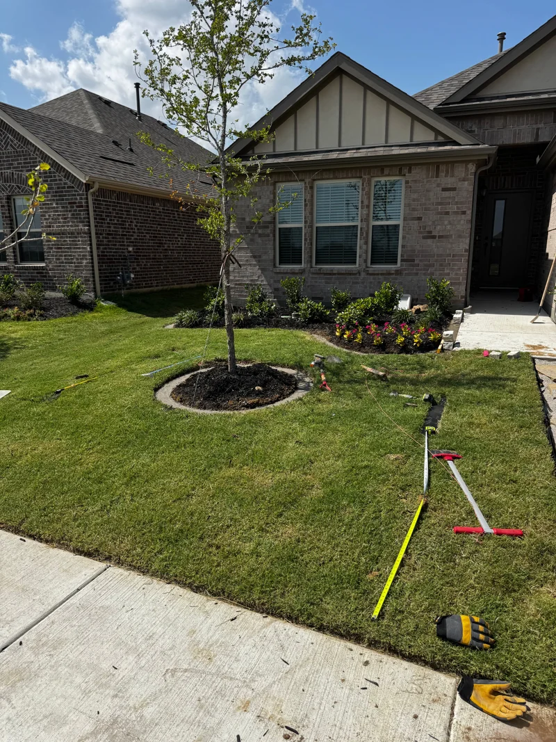 Fresh front-yard landscaping beside a brick home