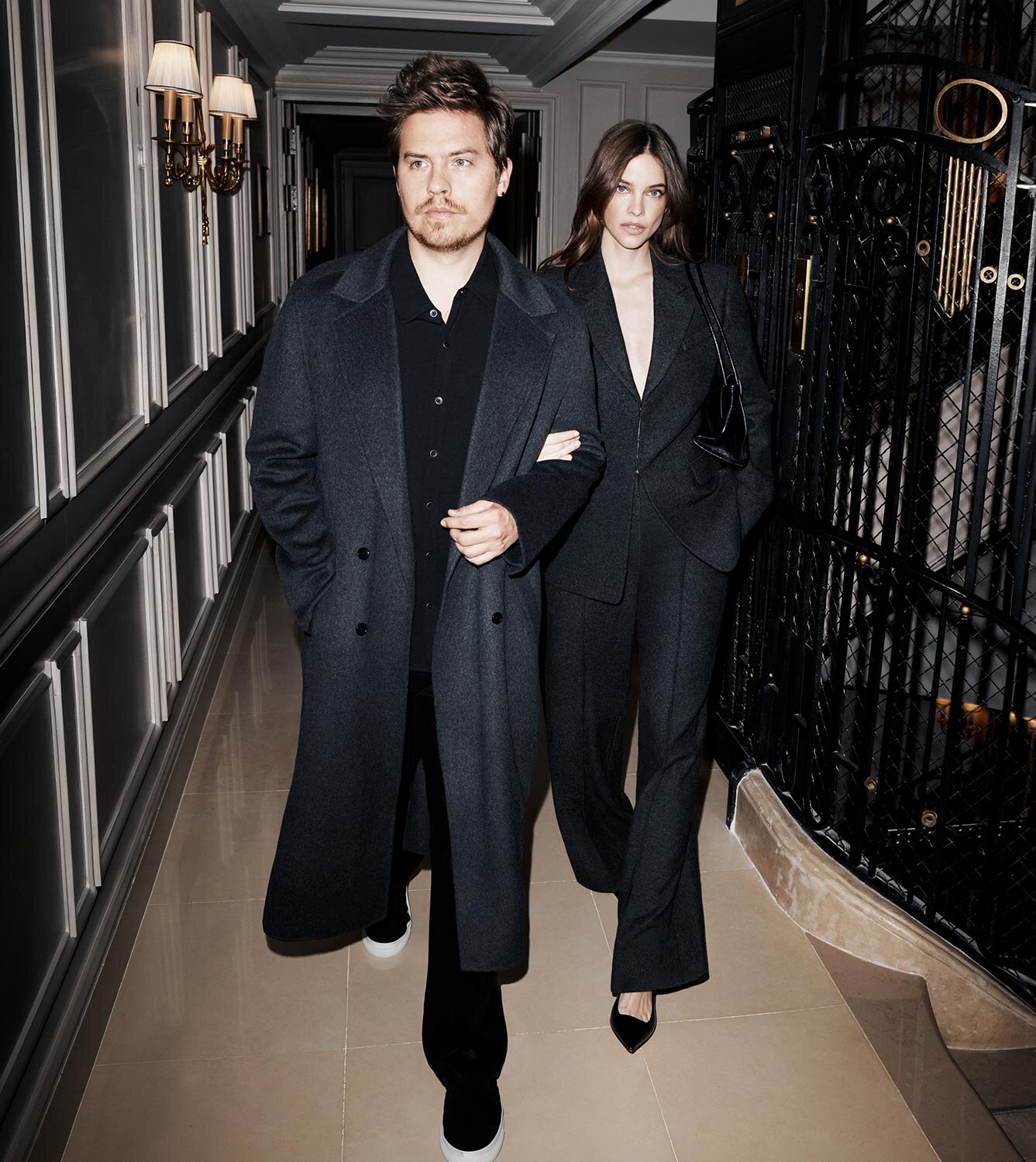 Dylan Spouse and Barbara Palvin wearing dark grey jackets and outfitting by PAIGE.