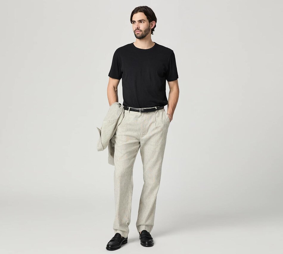 Man wearing a grey suiting jacket and trouser pant set with a black tee, black belt, and black loafers