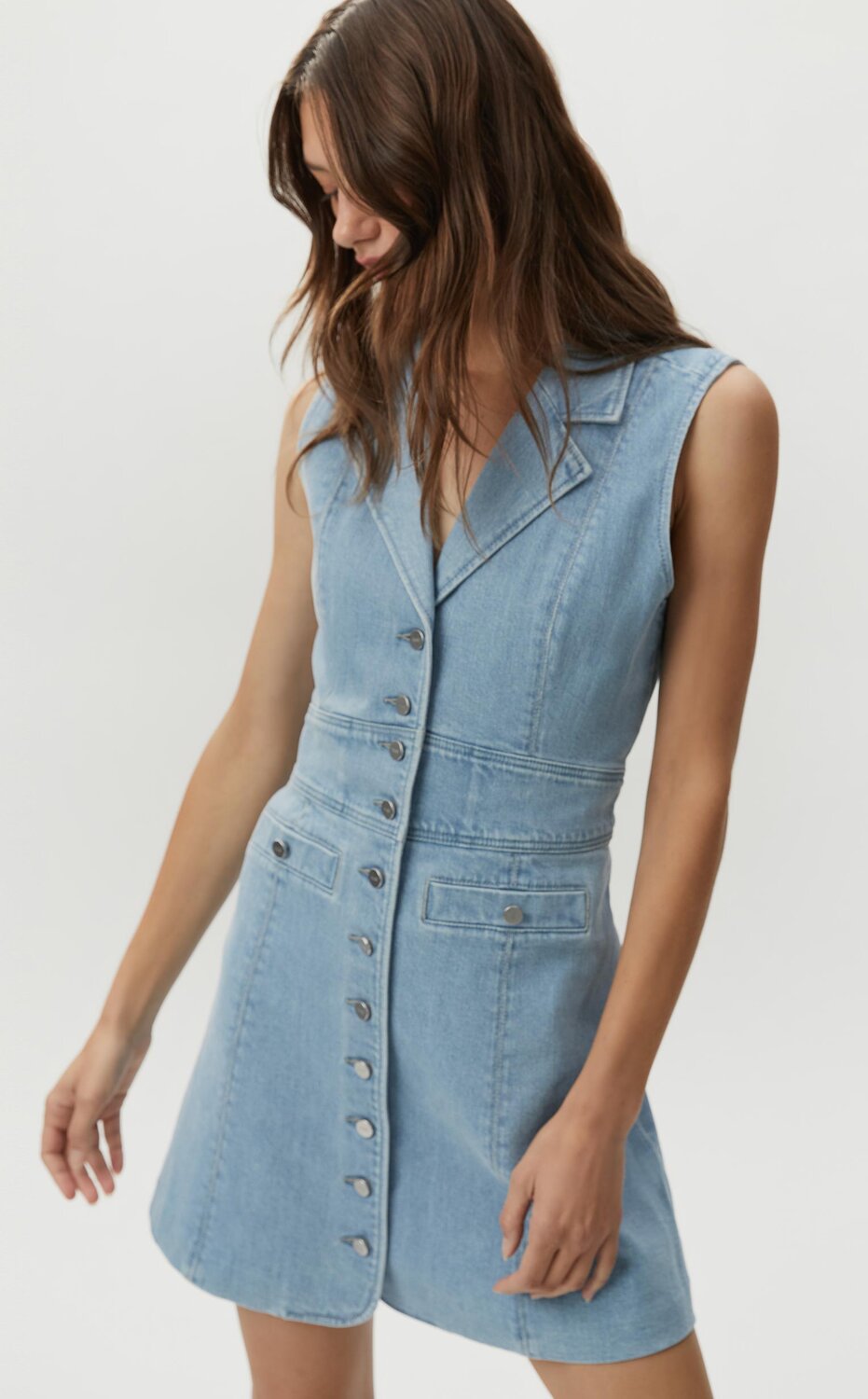 Woman wearing a light wash denim mini dress