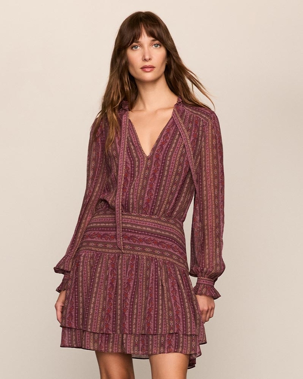 Woman wearing a mauve tapestry striped silk long sleeve mini dress