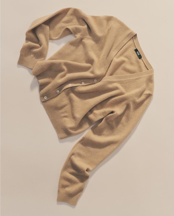 Flat lay of a beige button-front cardigan with ribbed cuffs and hem on a neutral background.