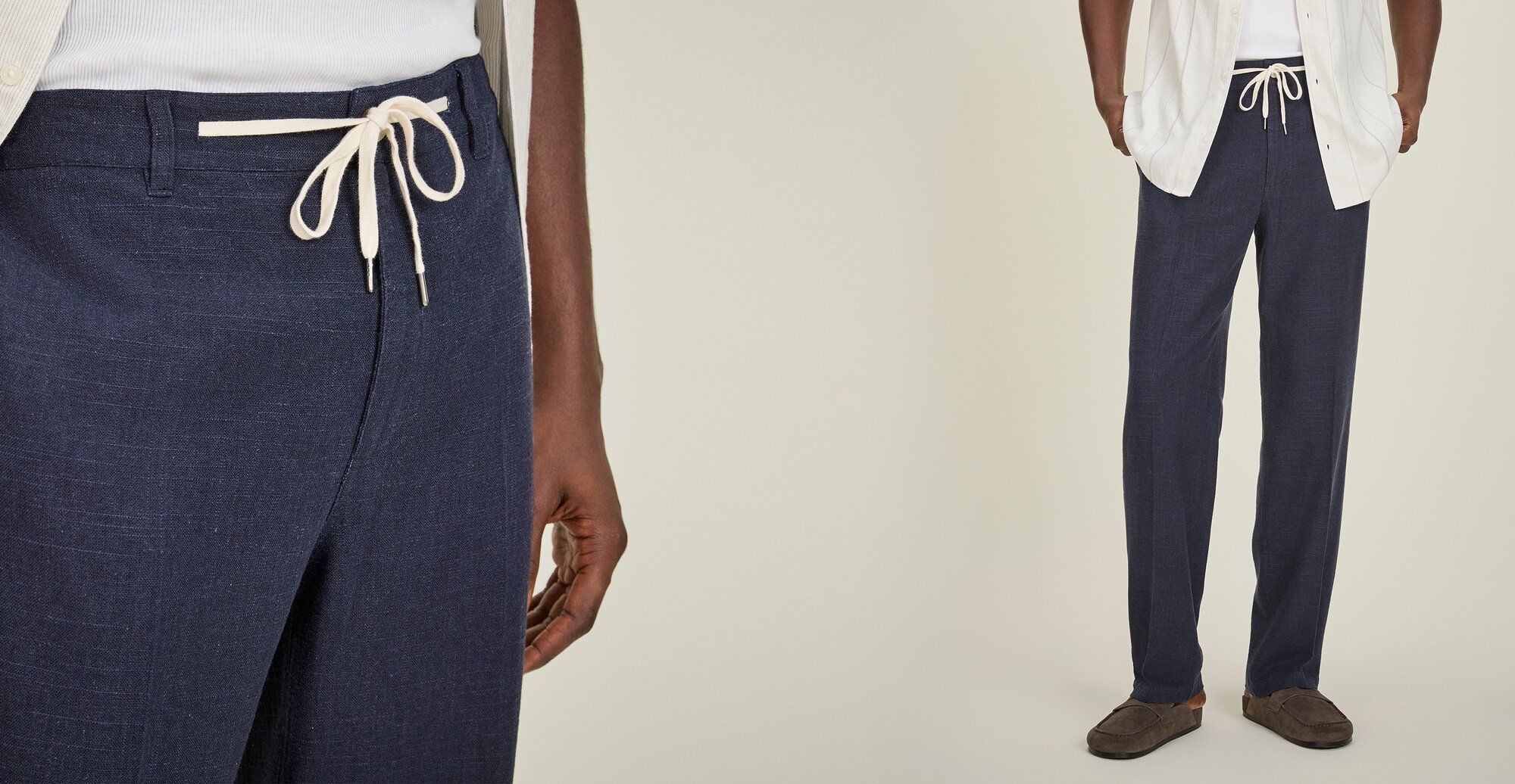 Close-up of navy drawstring pants with a white tie waist, styled with a white shirt.
