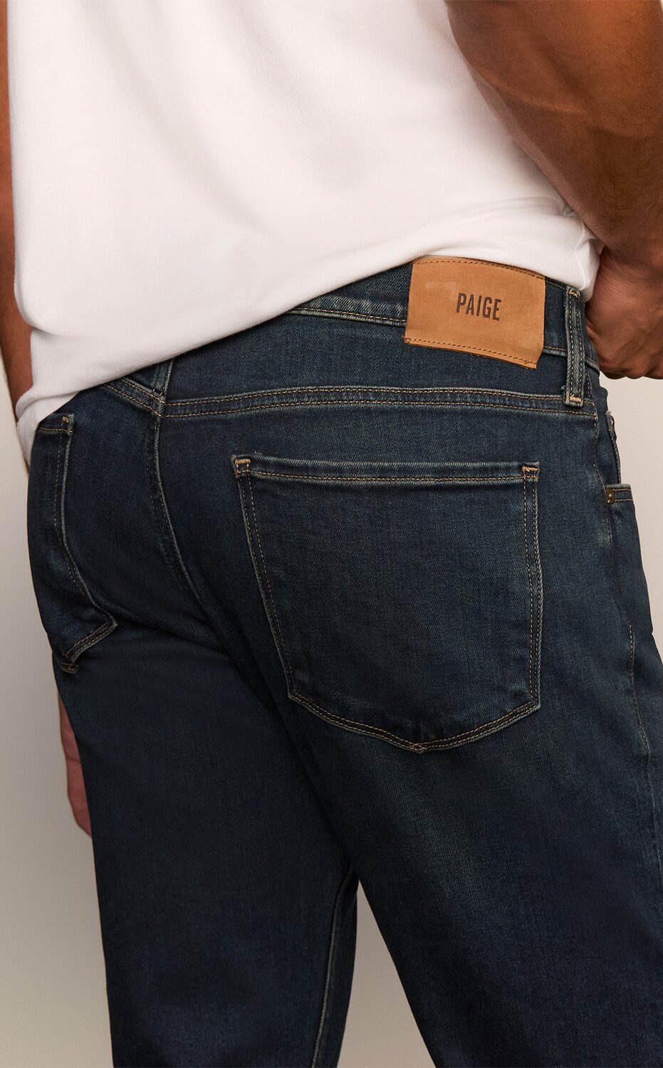A collection of PAIGE denim jeans in an array of washes from light to dark
