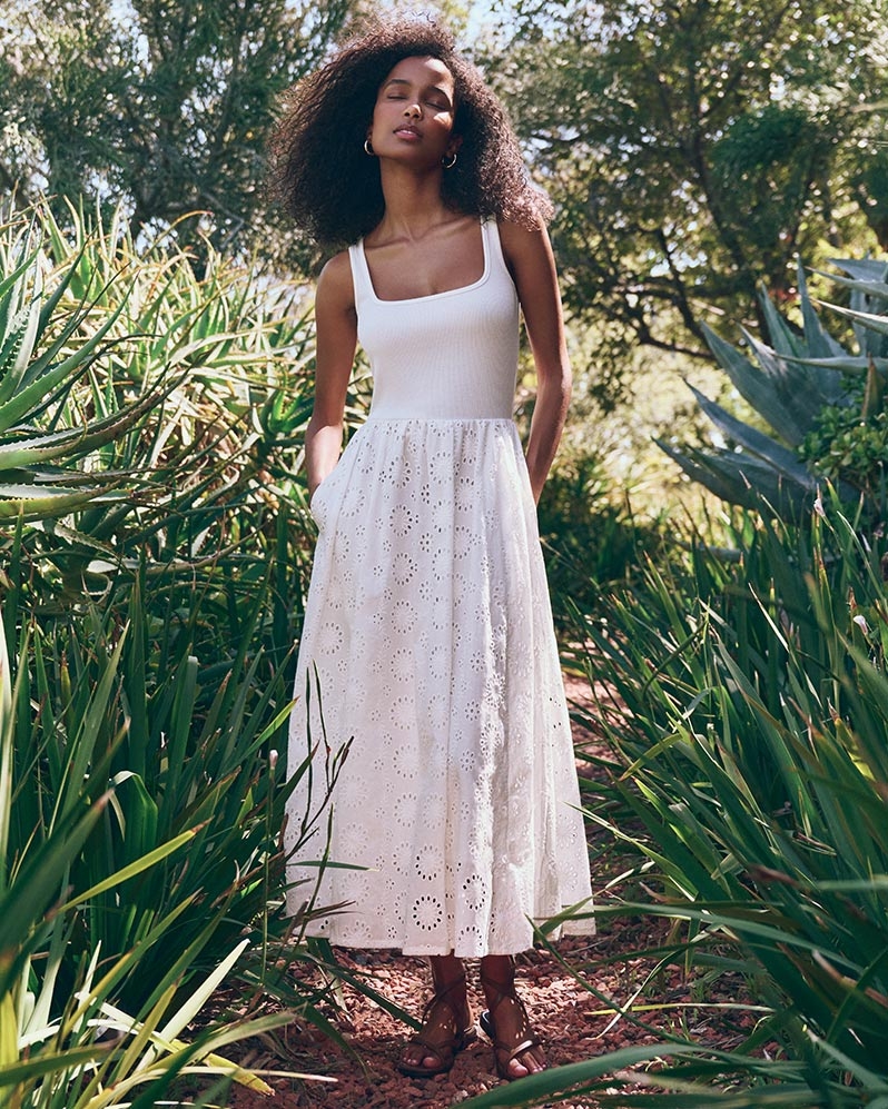 Woman wearing a white eyelet midi dress