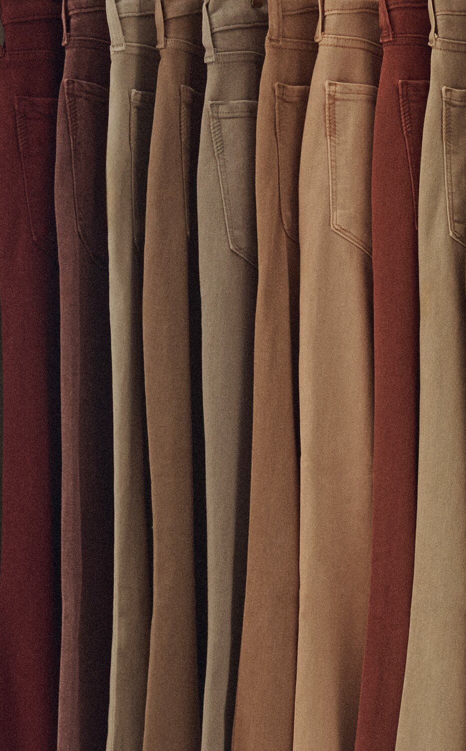 Men's Transcend Colour denim hanging on a rack in a range of washes