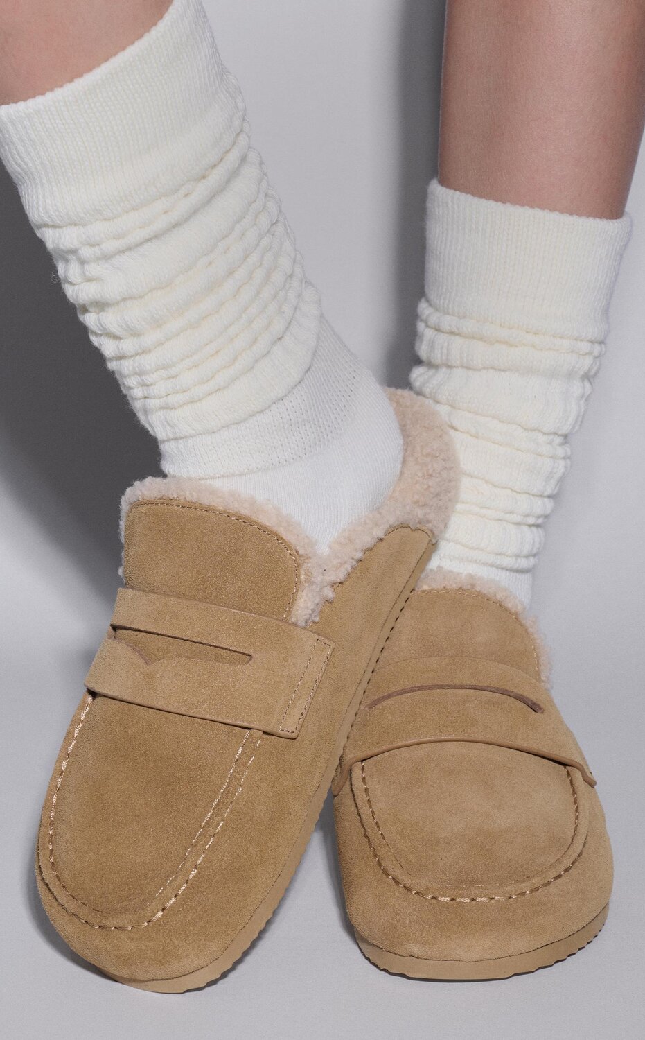 Woman wearing a green velvet mini dress with black pointed toe slingback pumps