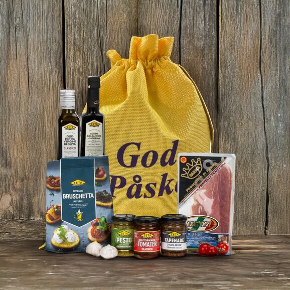 Eksklusiv påskegave med olivenolje, spekemat og gourmetprodukter i en 'God Påske'-pose – perfekt gave til matelskere.