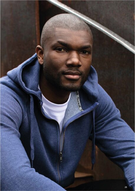 Mann i blå hettegenser fra Tracker, sitter avslappet 