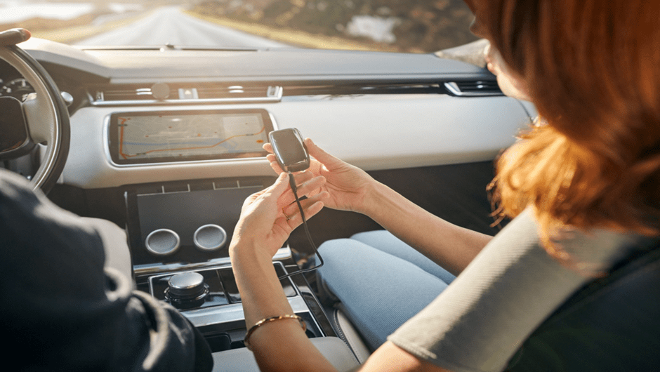 Holding the Ploom X Advanced device during a drive