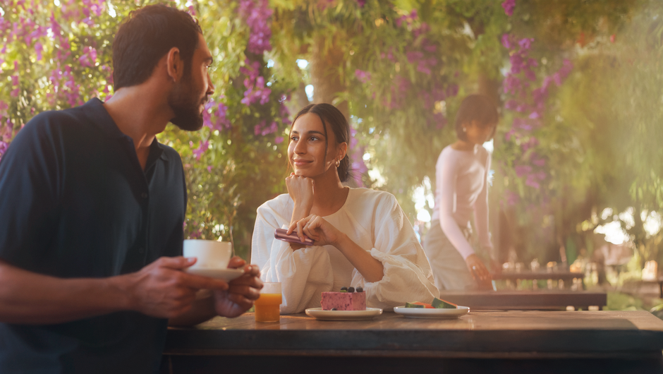 Couple enjoying a romantic moment under flowering trees.