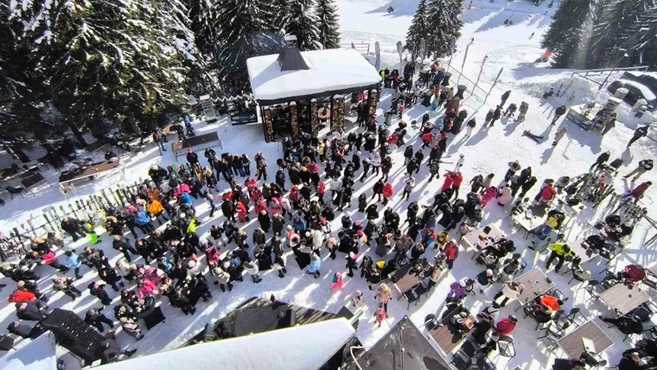Par uživa u romantičnom trenutku pod rascvetalim drvećem.