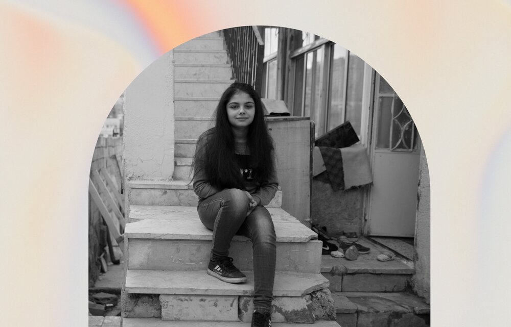 A young girl sitting on stairs