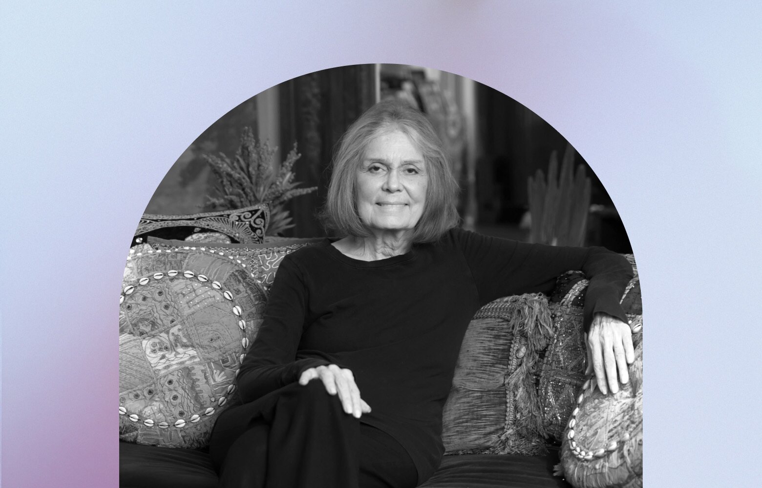 Gloria Steinem sitting on a couch
