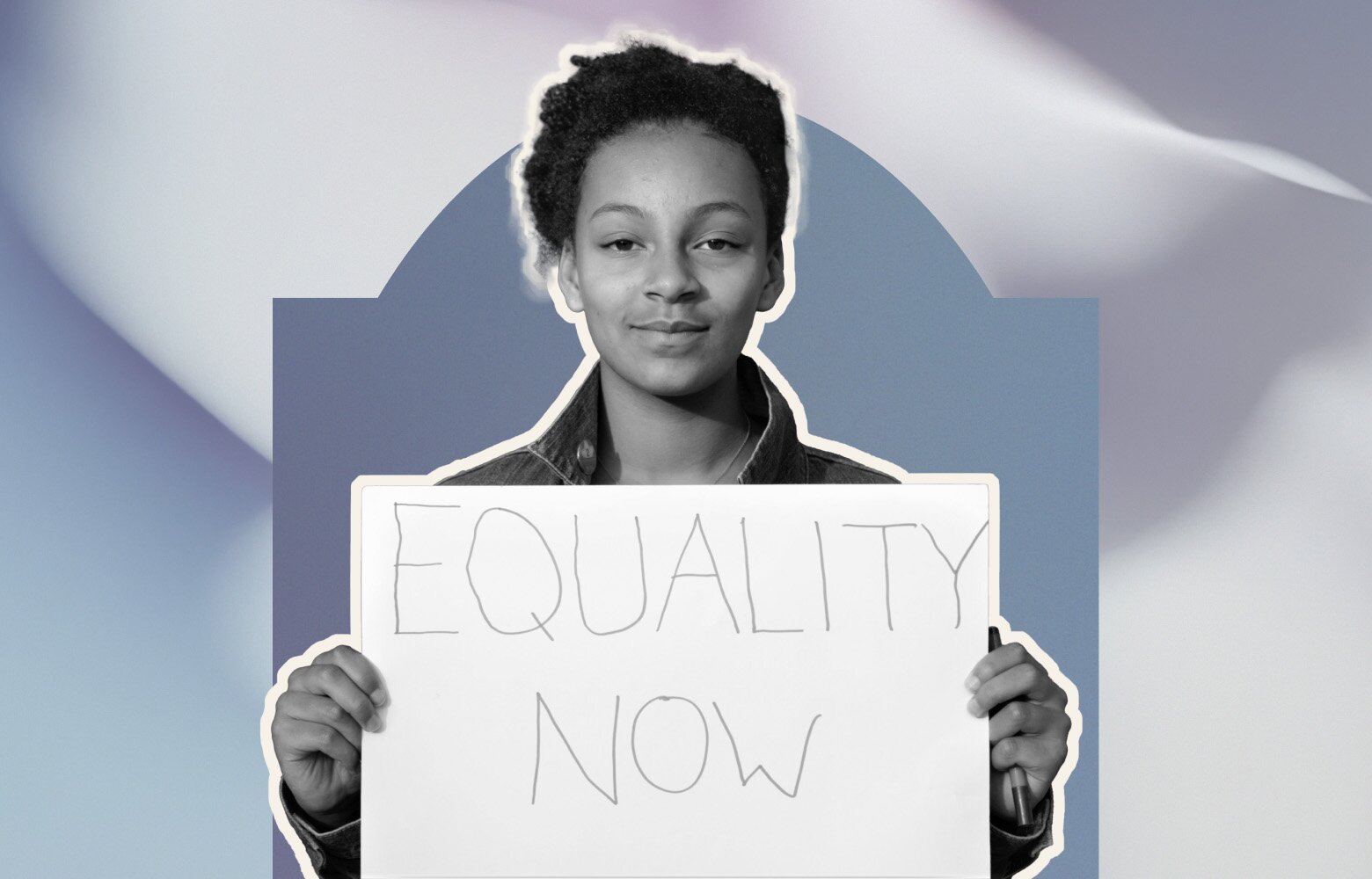 A young woman holding up a poster about equal rights