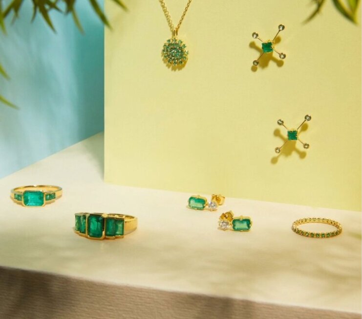 1 woman in a denim outfit and another woman in a white dress with black boots