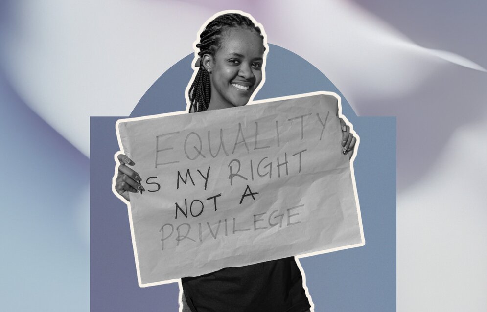 A young woman holding up a poster about equal rights
