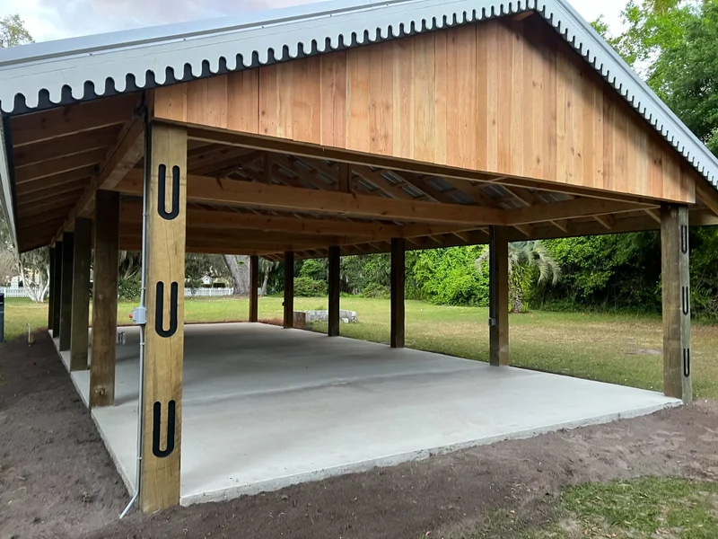 Open timber carport built over a concrete pad