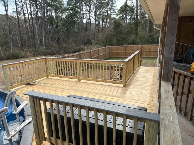 Large poolside deck with natural wood guardrails