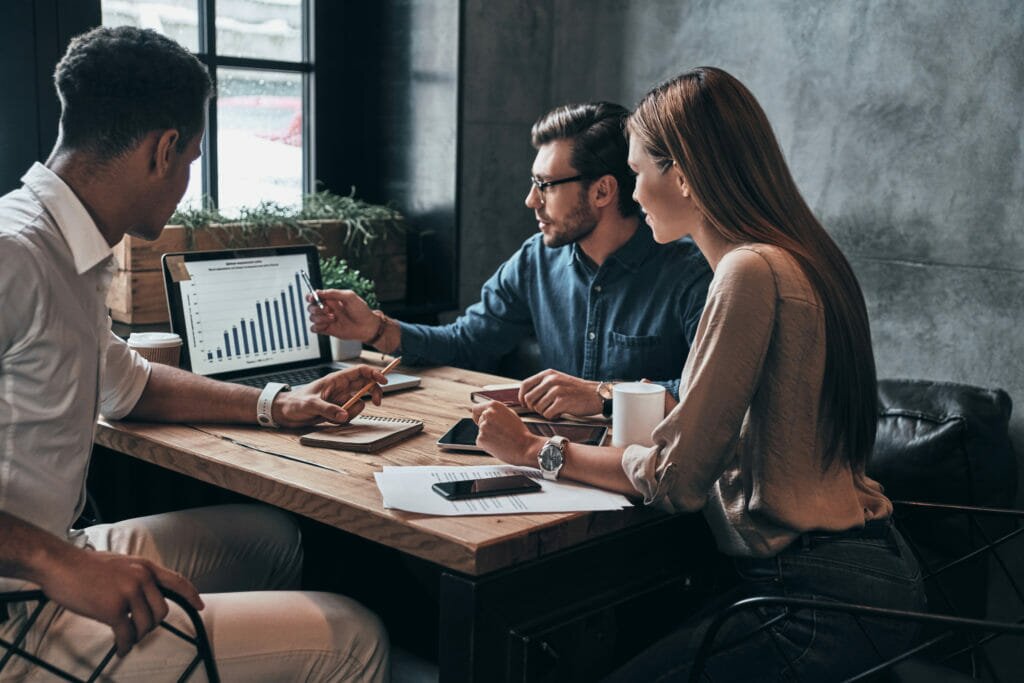 Three people in a business-to-business meeting