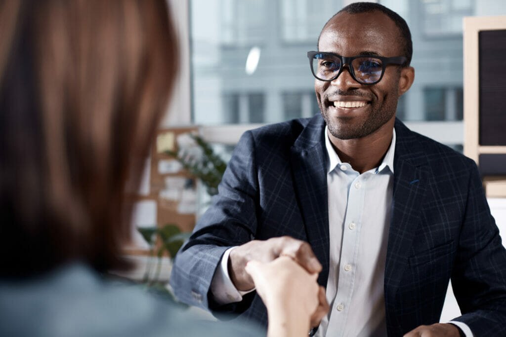 Man shaking a woman's hand at a job interview