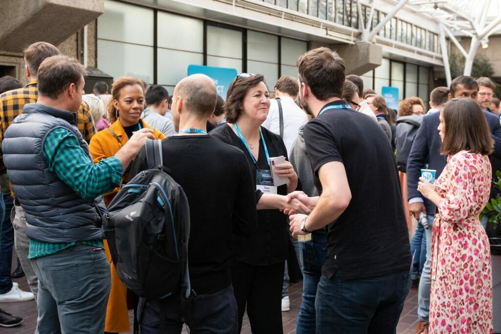 People chatting at a product management networking event