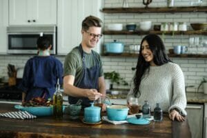 A man and a woman cooking together