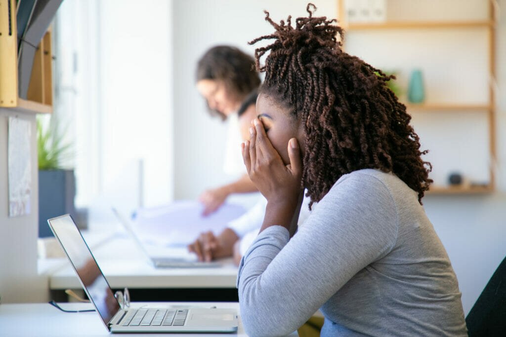 A woman looking stressed at work