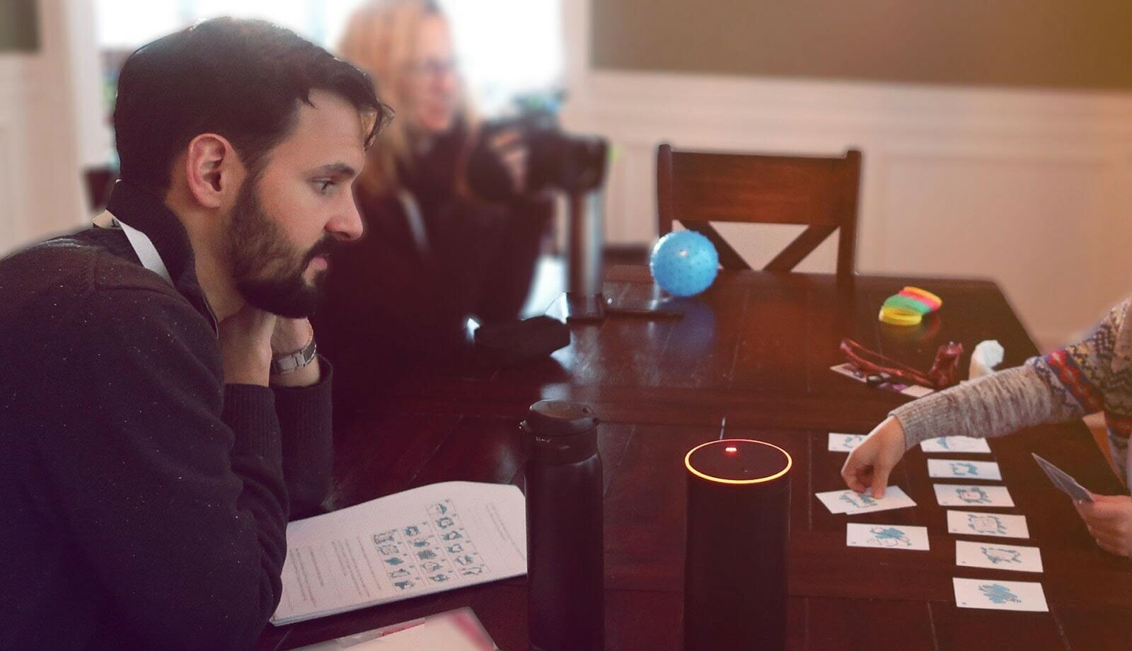 A researcher watching a child interact with a product prototype